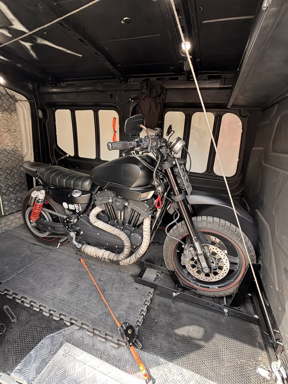 A custom cruiser secured in a wheel chock for transport