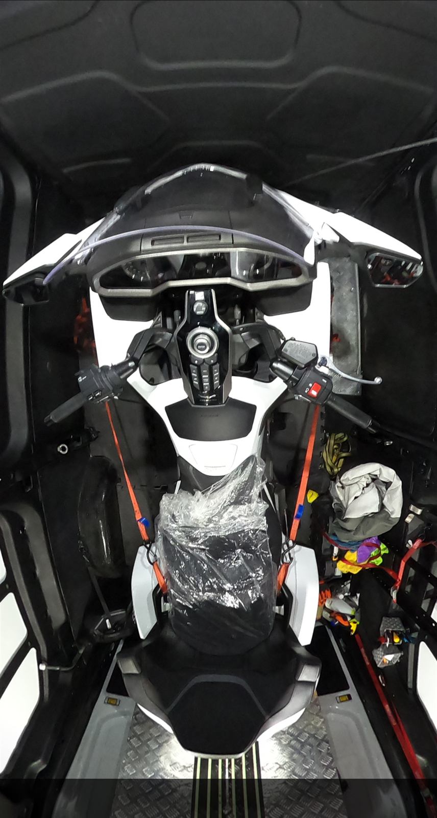 Top view of a motorcycle strapped down inside the van